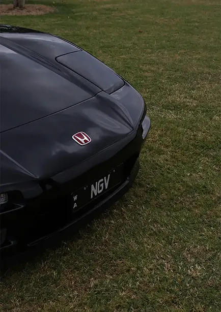 Bonnet and headlight shot of a black Honda NSX