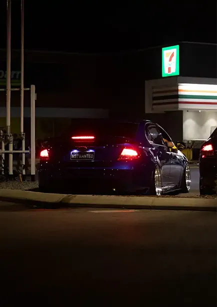 Rear 3/4 shot of a blue Ford FG Falcon at night