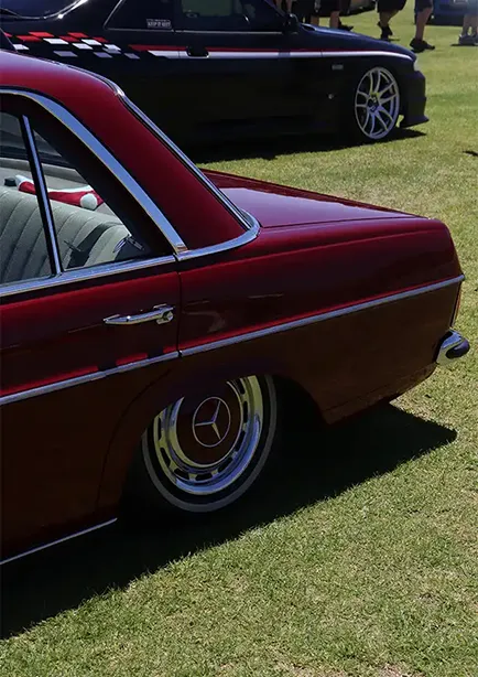 Rear side shot of a red classic Merdcedes Benz 220 Series